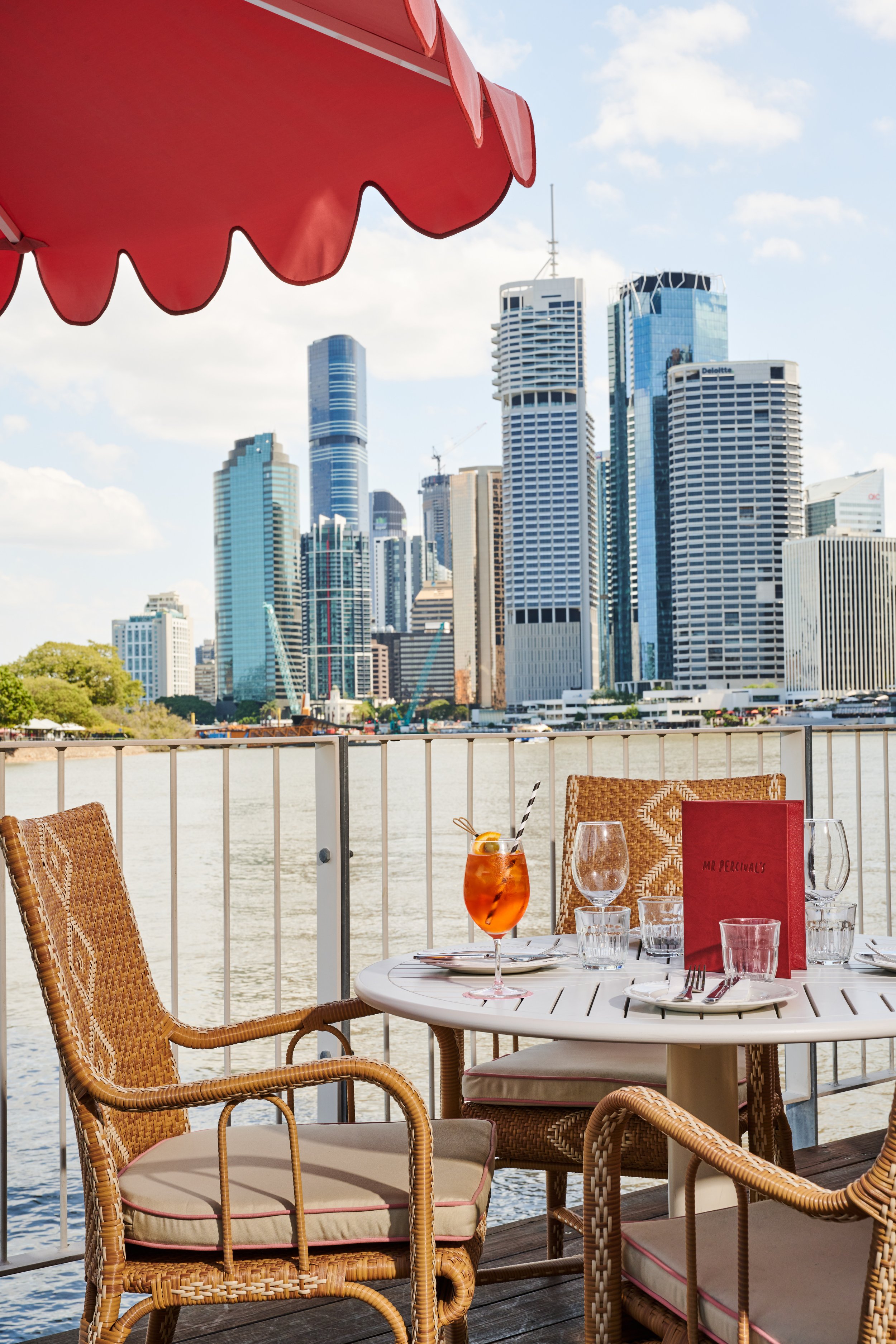 An outdoor table at Mr Percival’s overlooking the river and Brisbane skyline